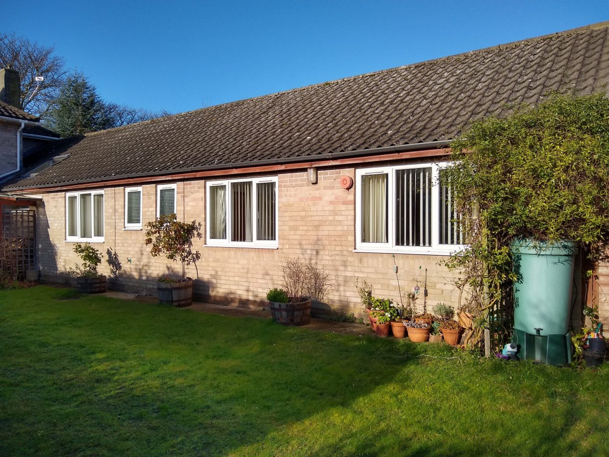 The single-storey garden annexe and lawn